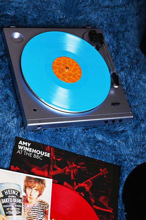 record player with a bright blue vinyl on a blue shag carpet